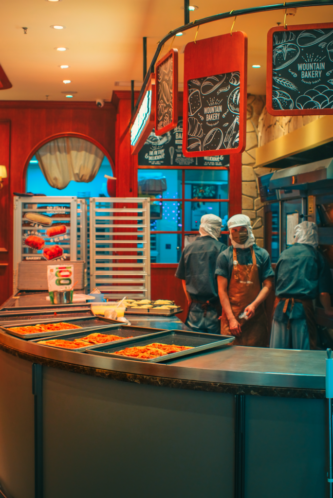 aerospace Industrial bakery scene with chefs preparing food, warm interior lighting adds ambiance.